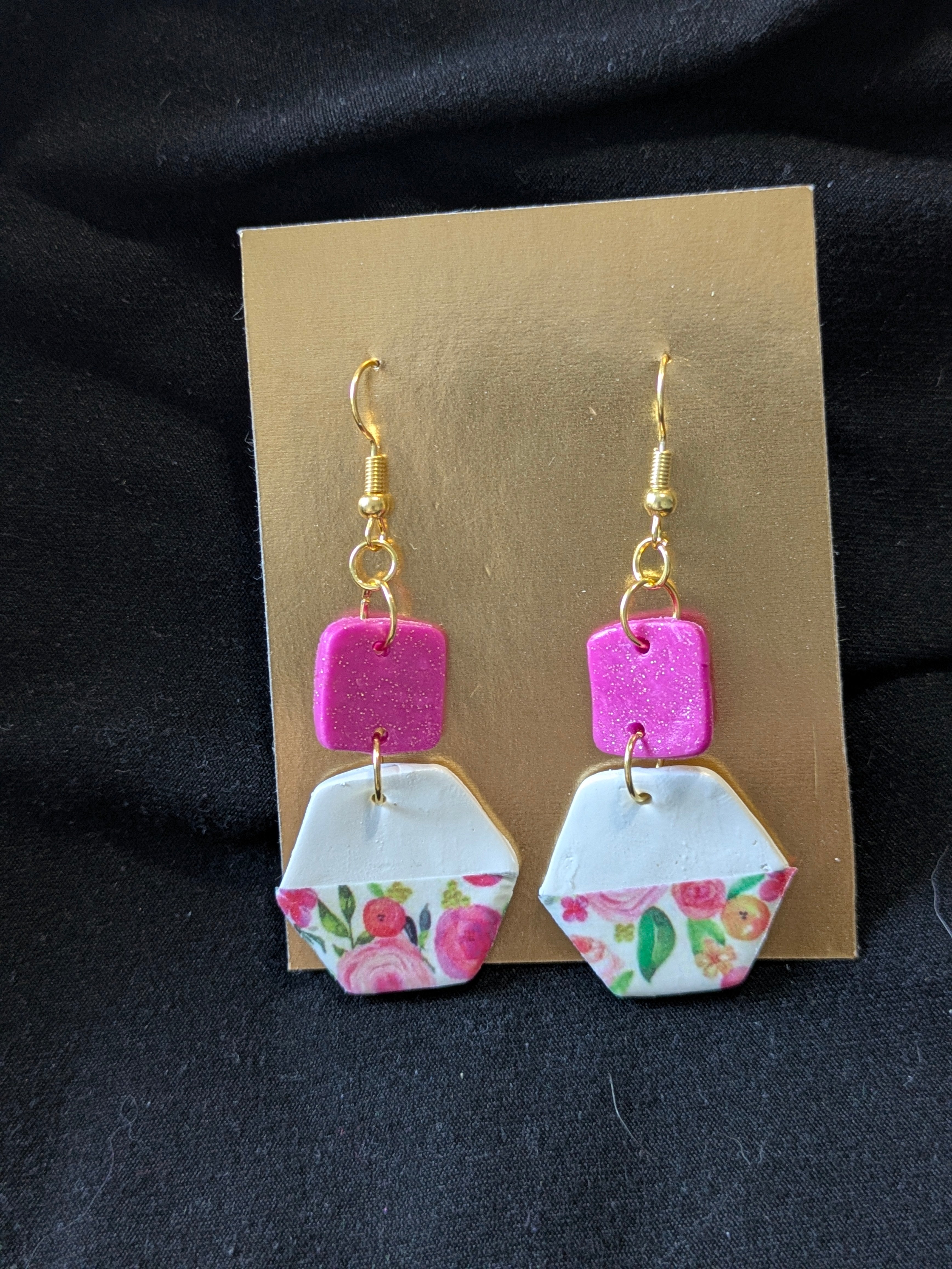 peonies on white clay with a pink square with sparkles