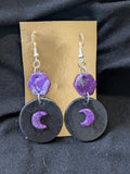 Purple and silver hexagons the top black circle with purple and silver moons