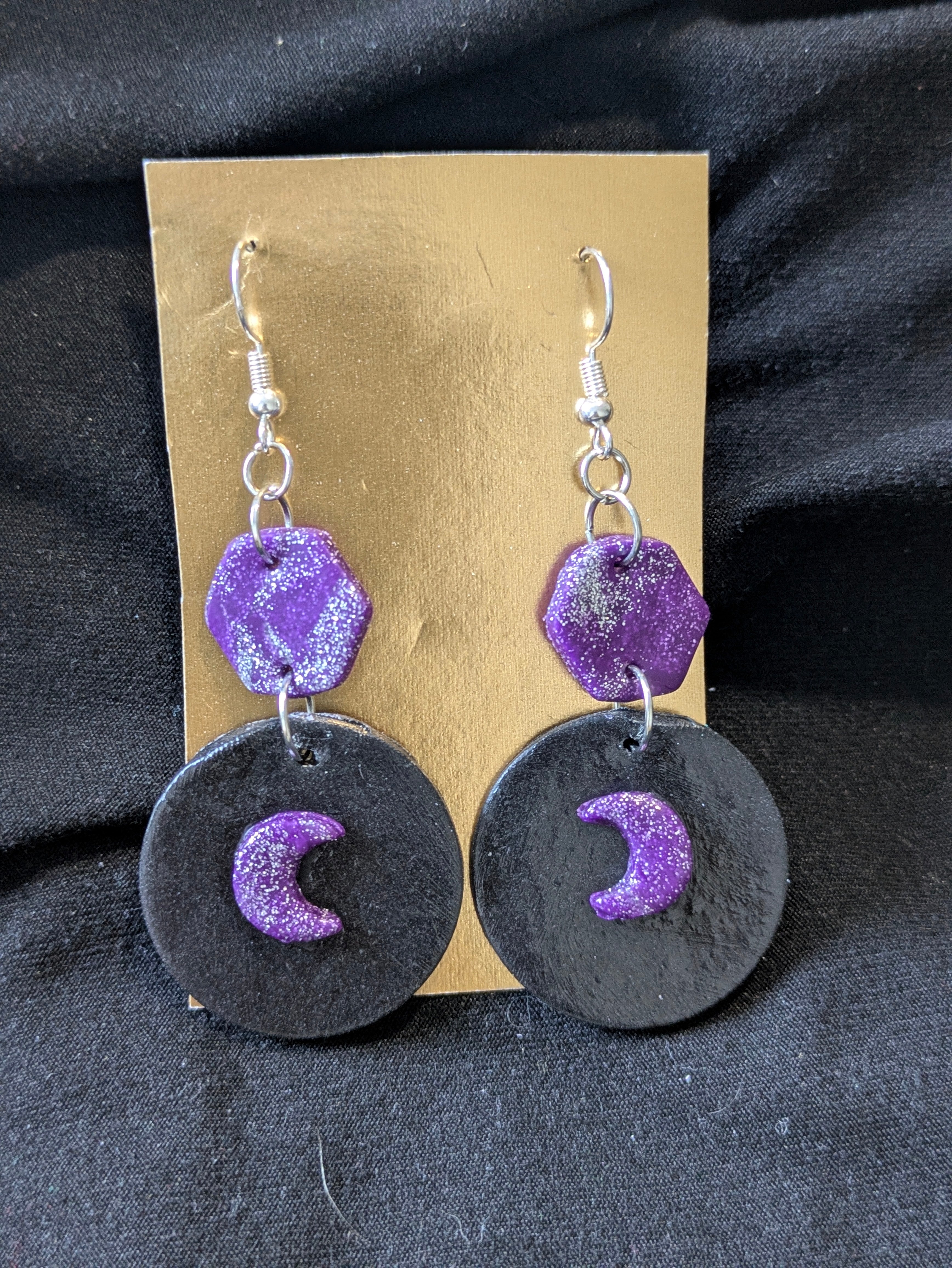 Purple and silver hexagons the top black circle with purple and silver moons