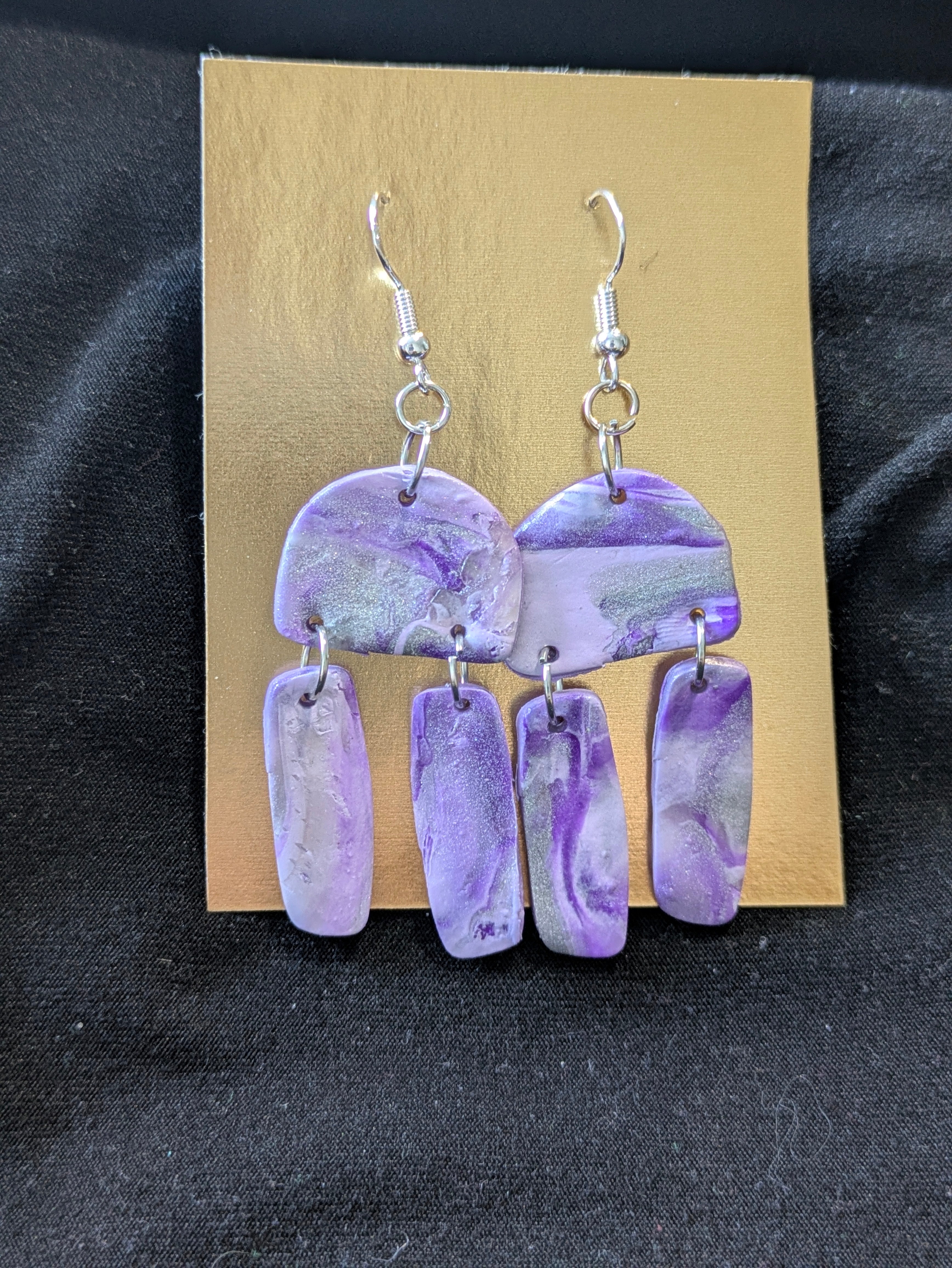 Purples, silver and translucent half circles and dangling rectangles