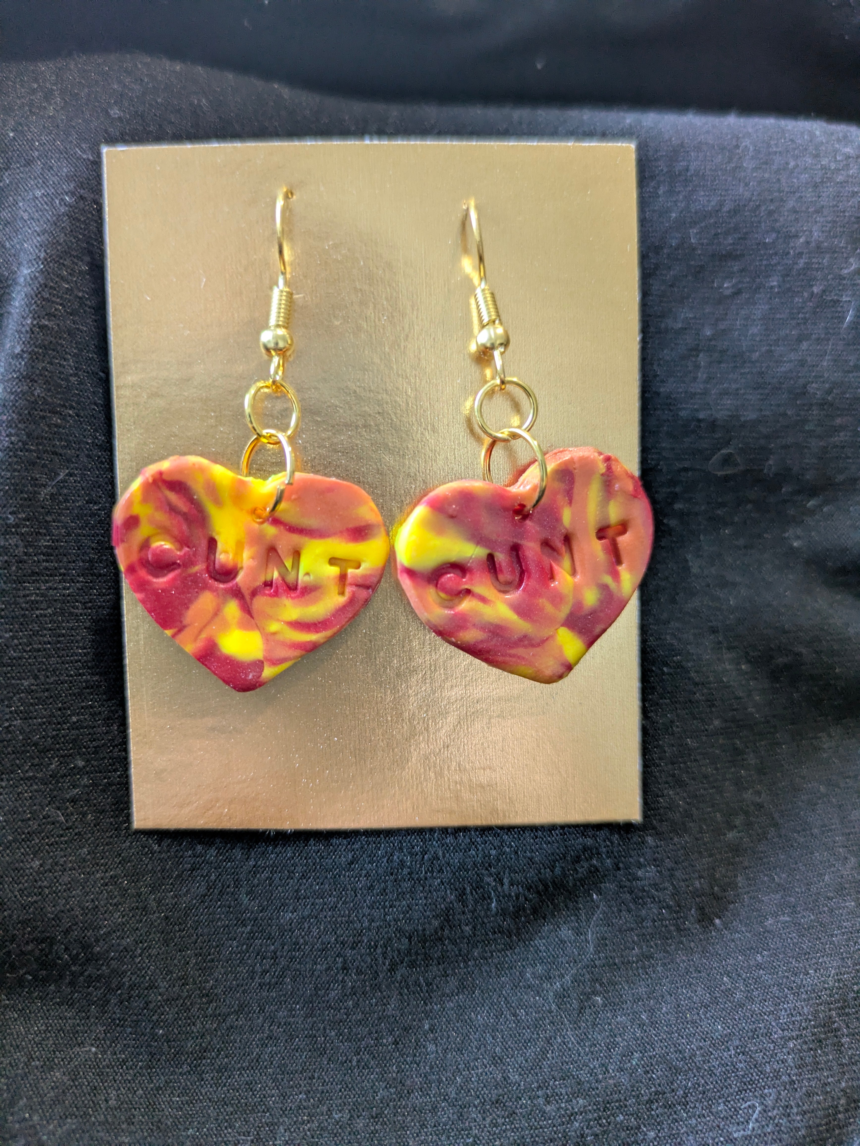 Red orange and yellow heart with cunt on it