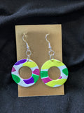 White circles with bright yellow, people, pink and green circles