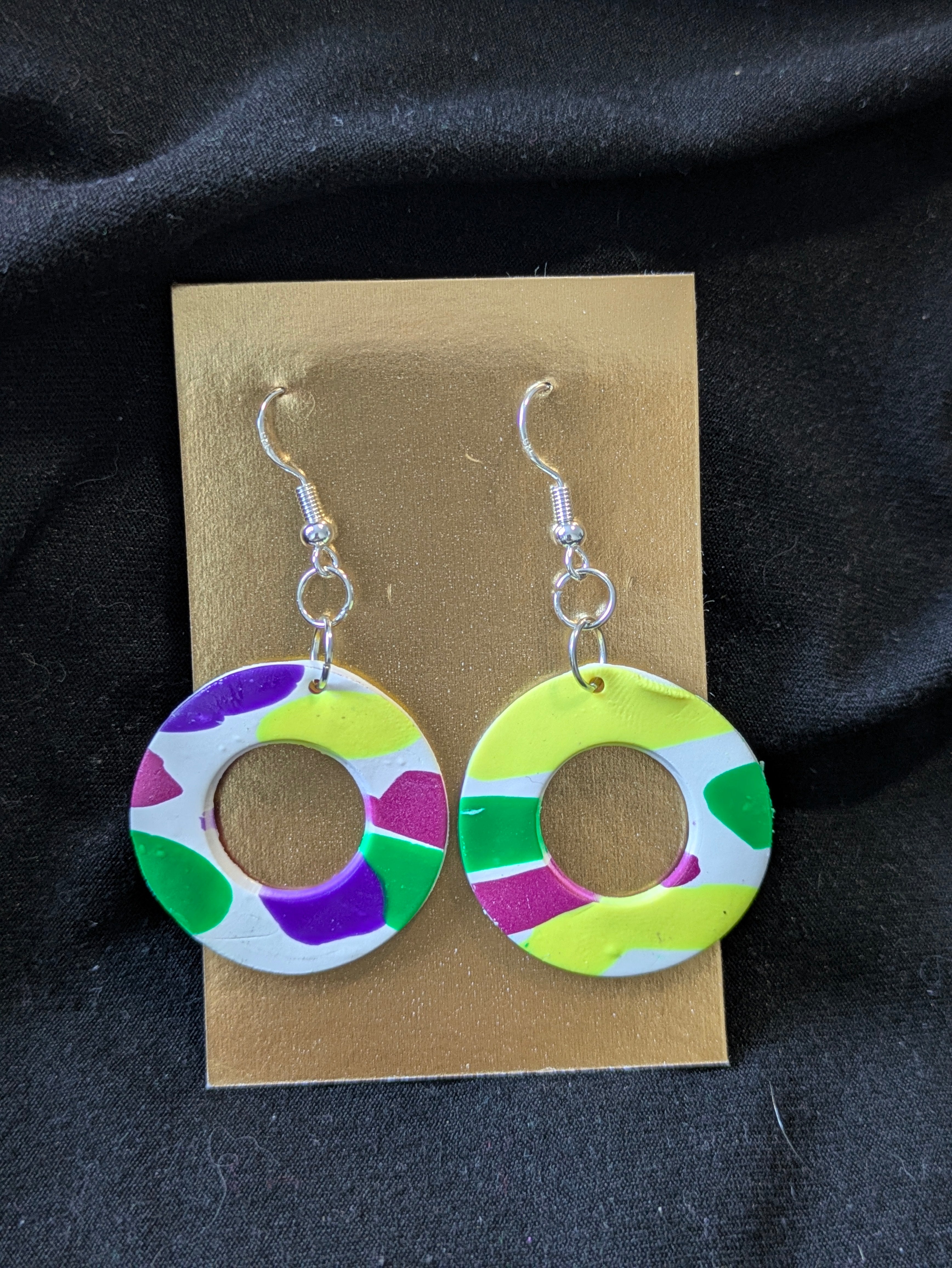 White circles with bright yellow, people, pink and green circles