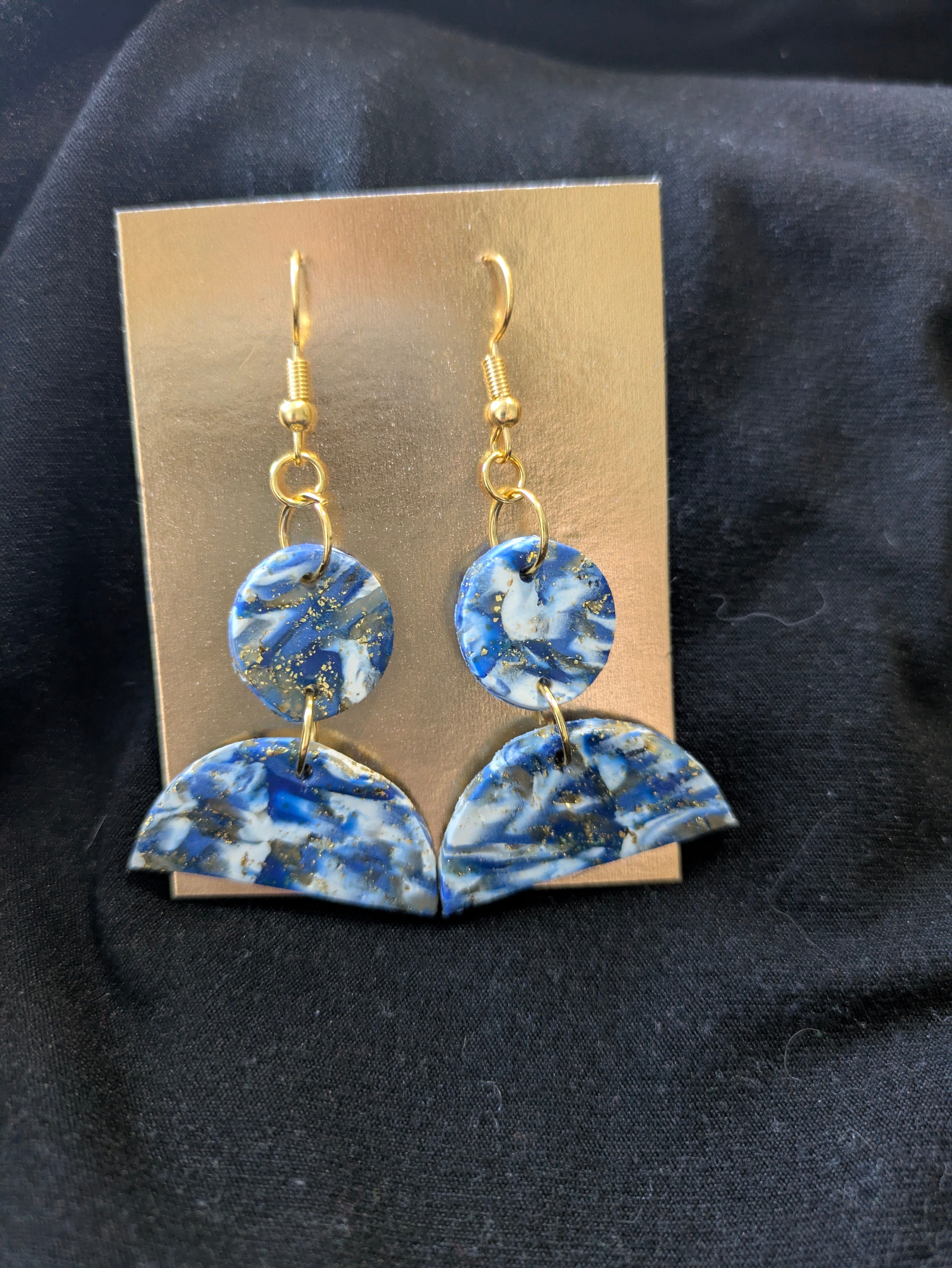 Blues and white with translucent and gold leafing in half circle below whole circle