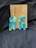 Teal gold and translucent half circle with dangly rectangles