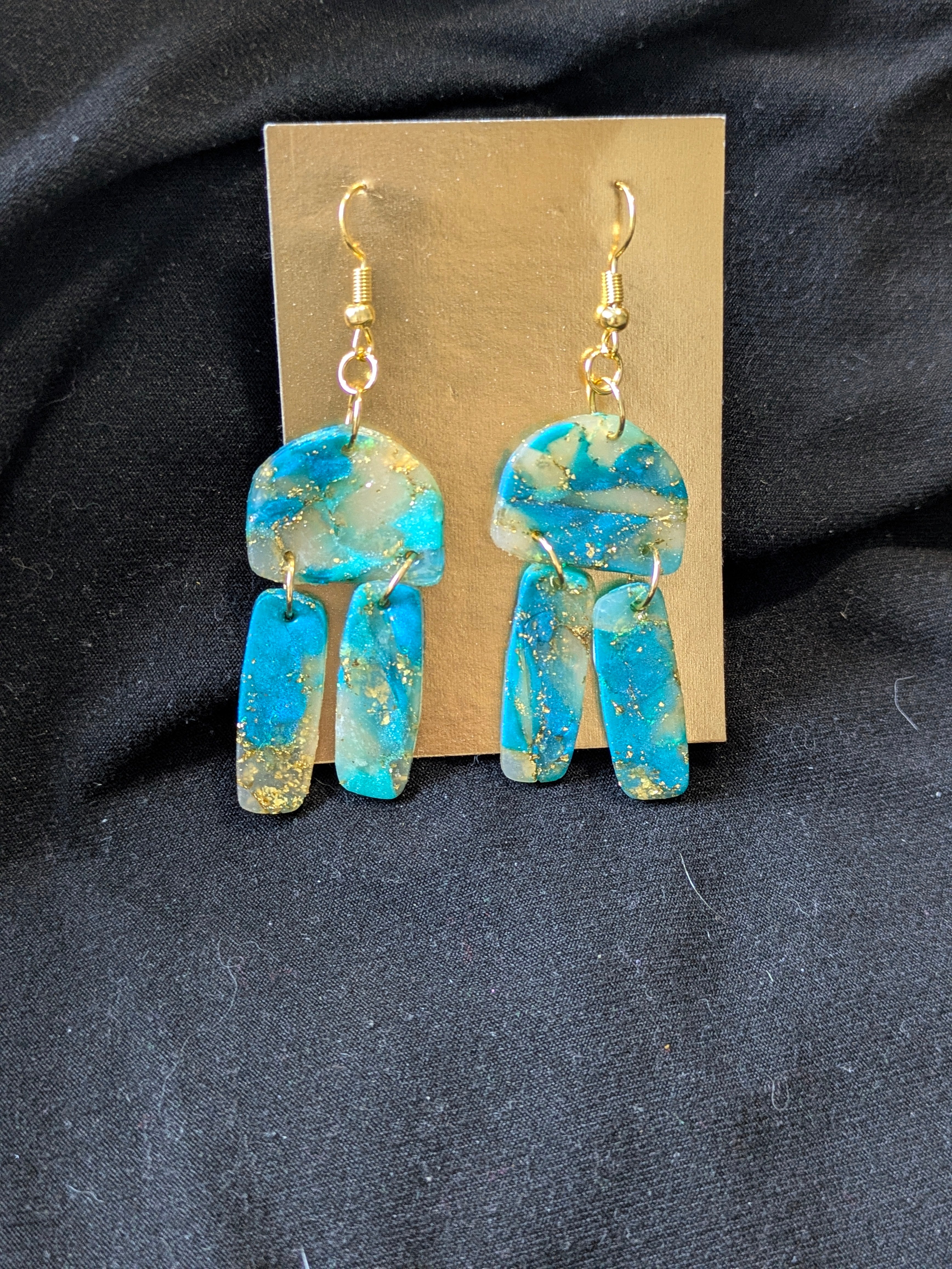 Teal gold and translucent half circle with dangly rectangles