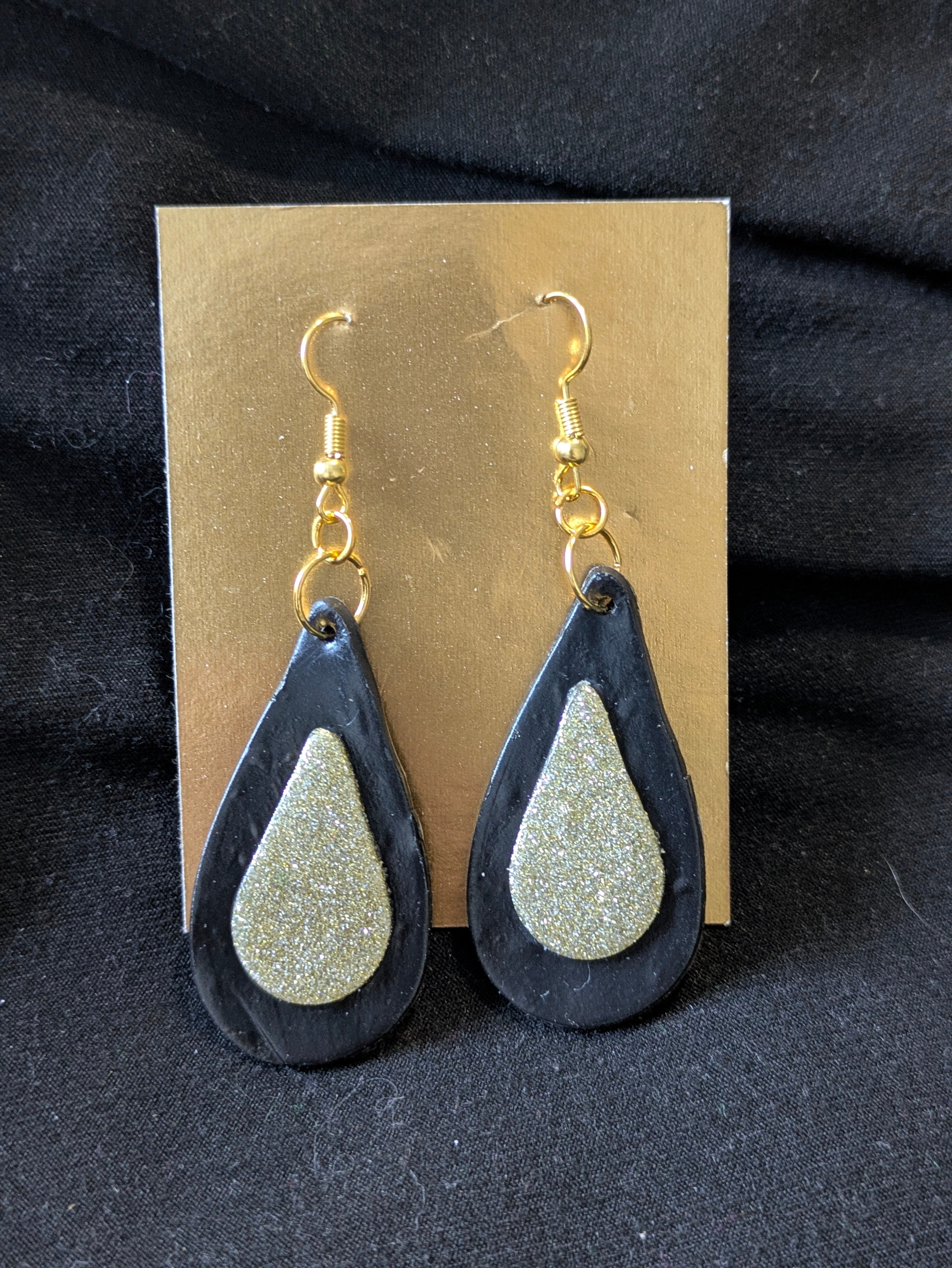 Gold drop on a larger black drop