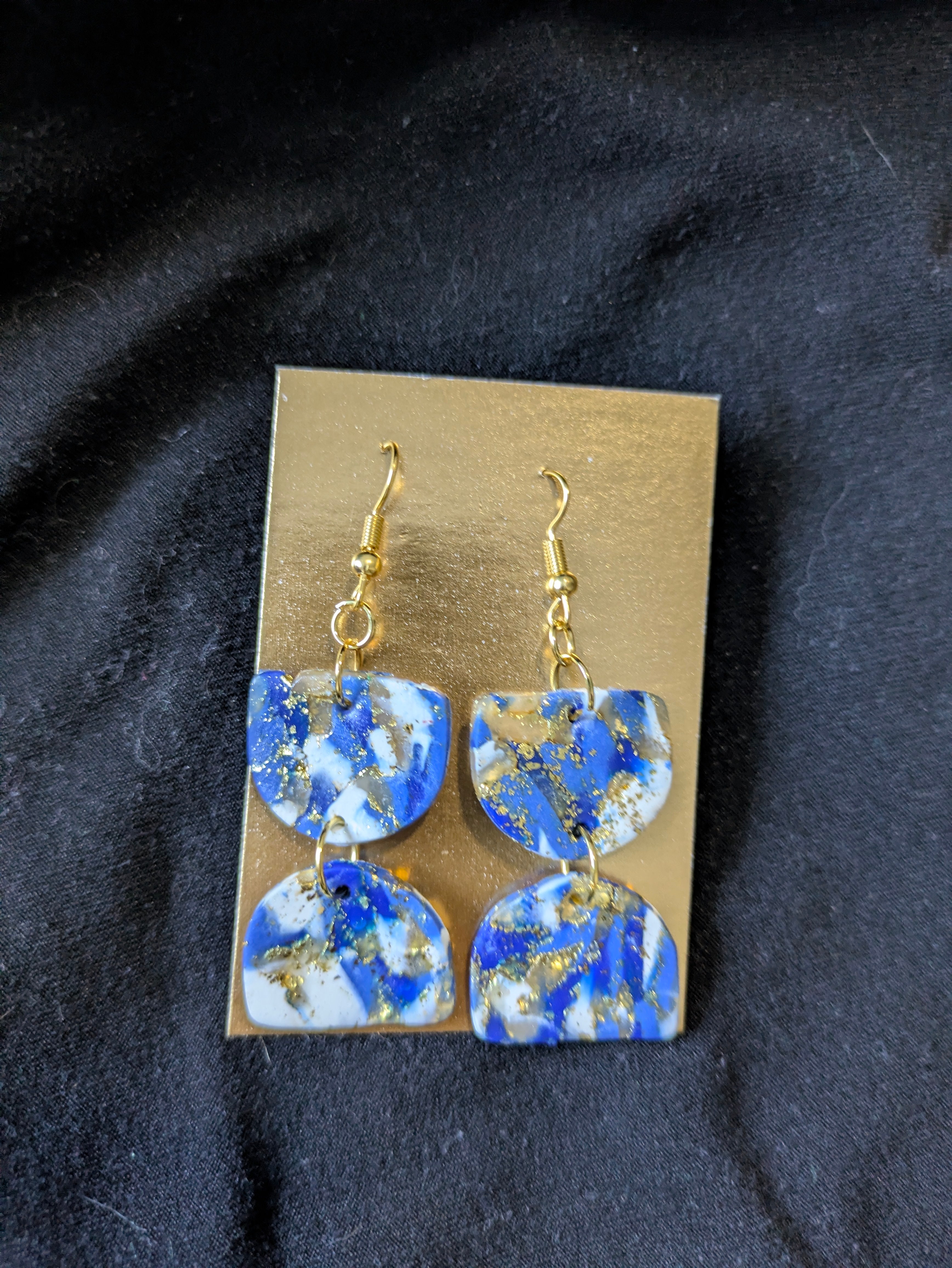 Blues and white with gold leafing half circles opposite themselves.