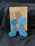 Blue purple and green butterflies with flower