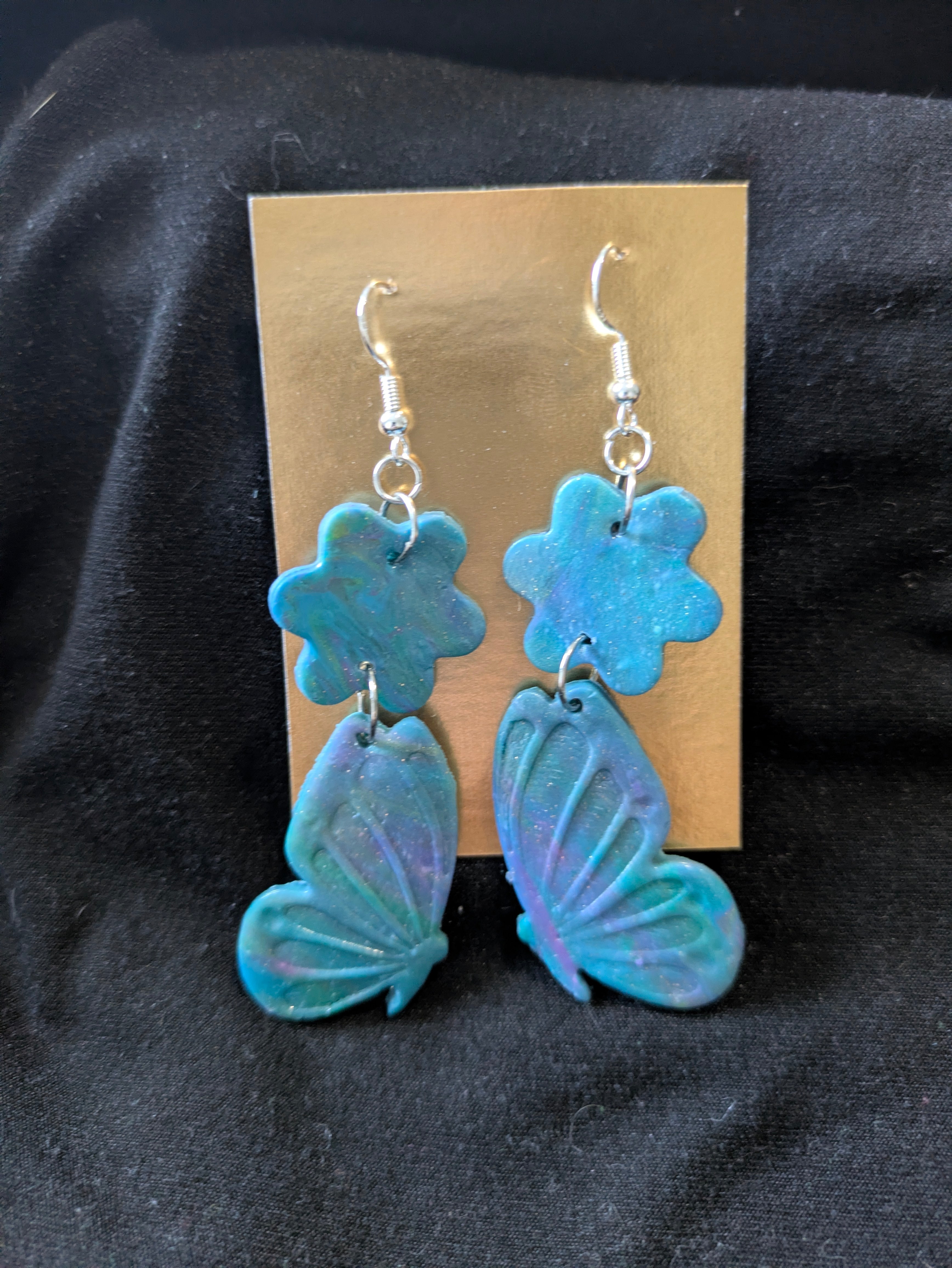 Blue purple and green butterflies with flower